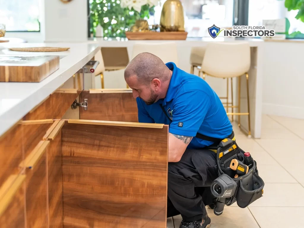 South Florida home inspector inspecting kitchen cabinets during a full home inspection in Miami, FL