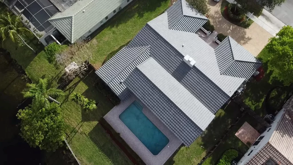 Aerial view of a South Florida home showing tile roof and pool during a 4 point and wind mitigation inspections by South Florida Inspectors