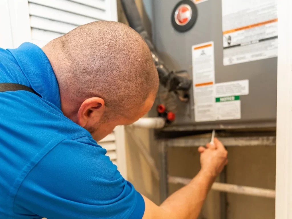 Home inspector examining an AC and HVAC unit up close during a home inspection in Miami, South Florida Inspectors